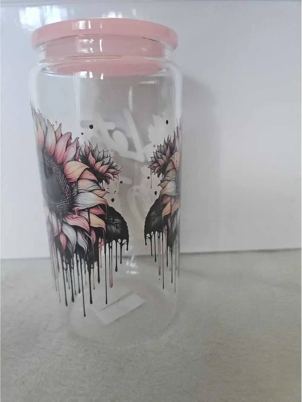 16 oz glass cup with acrylic Lid. Comes w/ straw and straw cleaner.